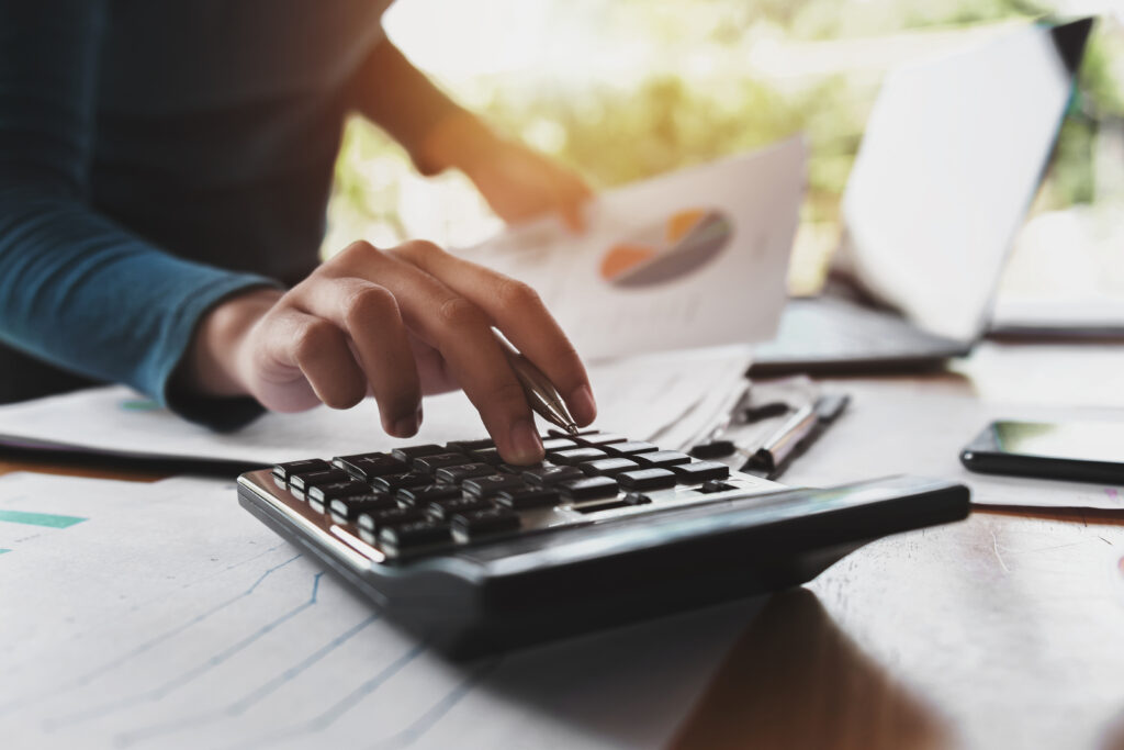 Close up hand of an Accounting & Advisory Services woman using calculator for Zoar Finance